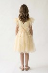 Girl styled in Paola buttercup tulle dress for a family celebration