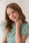 Girl styled in the Paola mint tulle occasion dress for a party