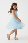 Close-up of glitter tulle detail on light blue girls party dress