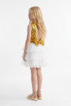 Riva white and gold party dress – angled back view showing the cut-out, the sequin bow at the waist and the tulle layers