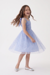 Rina girls' cornflower blue dress – flared tulle skirt with coloured sequins, girl twirling, full length