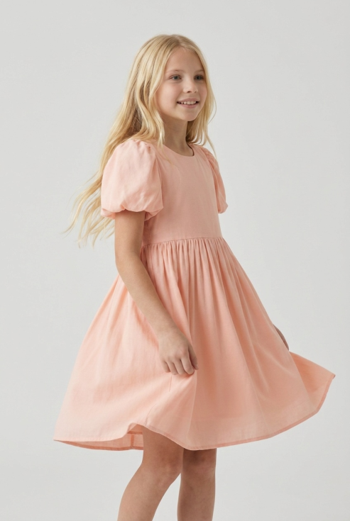 Sia girls' pink party dress with puff sleeves – front view, skirt in motion
