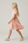 Sia pink party dress – profile view, flared knee-length skirt in motion