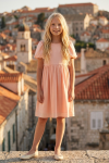 Sia pink party dress – full-length front view against the old town