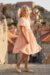 Sia pink party dress – side view against old town rooftops