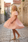 Sia girls' pink dress – twirling on a cobbled old town lane
