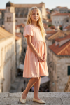 Sia pink dress – full-length view with an old town tower in the background