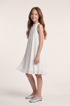 Rozalia white pleated dress – side view showing the knee-length A-line cut
