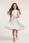 Rozalia girls' white pleated dress – front view with the flared hem in motion