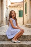Harper light blue party dress outdoors – seated pose