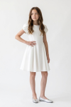 Rumi girls' white flared dress – hand on hip, front view