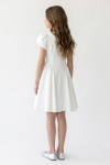 Rumi white dress – back view with the pointed waist seam and gathered skirt