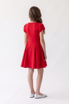 Rumi red dress – back view with zip and gathered sides of the skirt