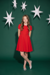 Rumi red dress – full length against a green backdrop with white stars