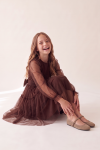 Holly chocolate brown tulle dress with bow at the waist – seated pose