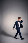 Sam boys' navy set with black bow tie – boy in motion, open blazer, full length