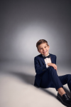 Sam navy boys' occasion set with black bow tie – boy sitting on the floor, front view