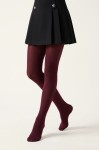 Girls' burgundy opaque tights – on a model mid-step, front view