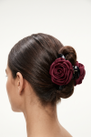 Burgundy rose claw clip holding a bun – back view