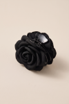 Girls' black claw clip with a fabric rose on a beige background – three-quarter view