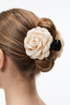 Hair claw clip with a beige fabric rose holding a bun – back view