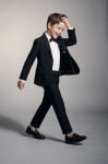 Sam boys' black 3-piece occasion set with blazer, trousers and bow tie – boy in motion, open blazer, full length