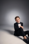 Sam black boys' set with bow tie – boy sitting on the floor, front view